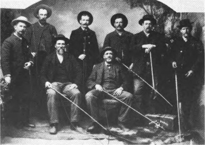 Photo of
                Charles Laird with seven other stage coach drivers.